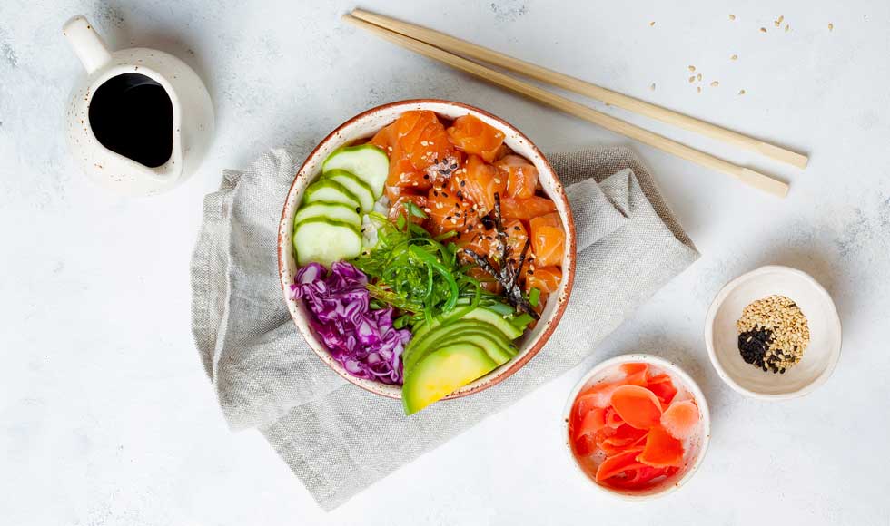 Hawaiian salmon poke bowl with seaweed, avocado, mango, pickled ginger, sesame seeds