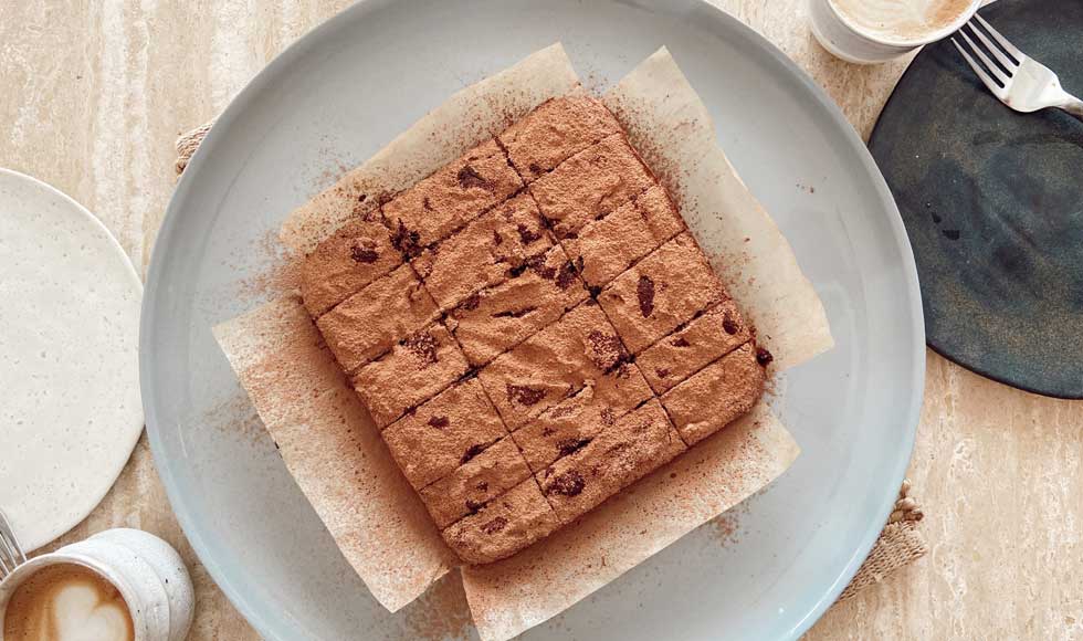Sweet potato brownies on a blue plate and baking paper